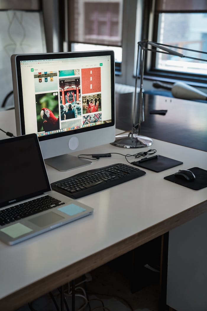 impact-img A sleek, modern office desk setup with computers and gadgets, perfect for productivity.